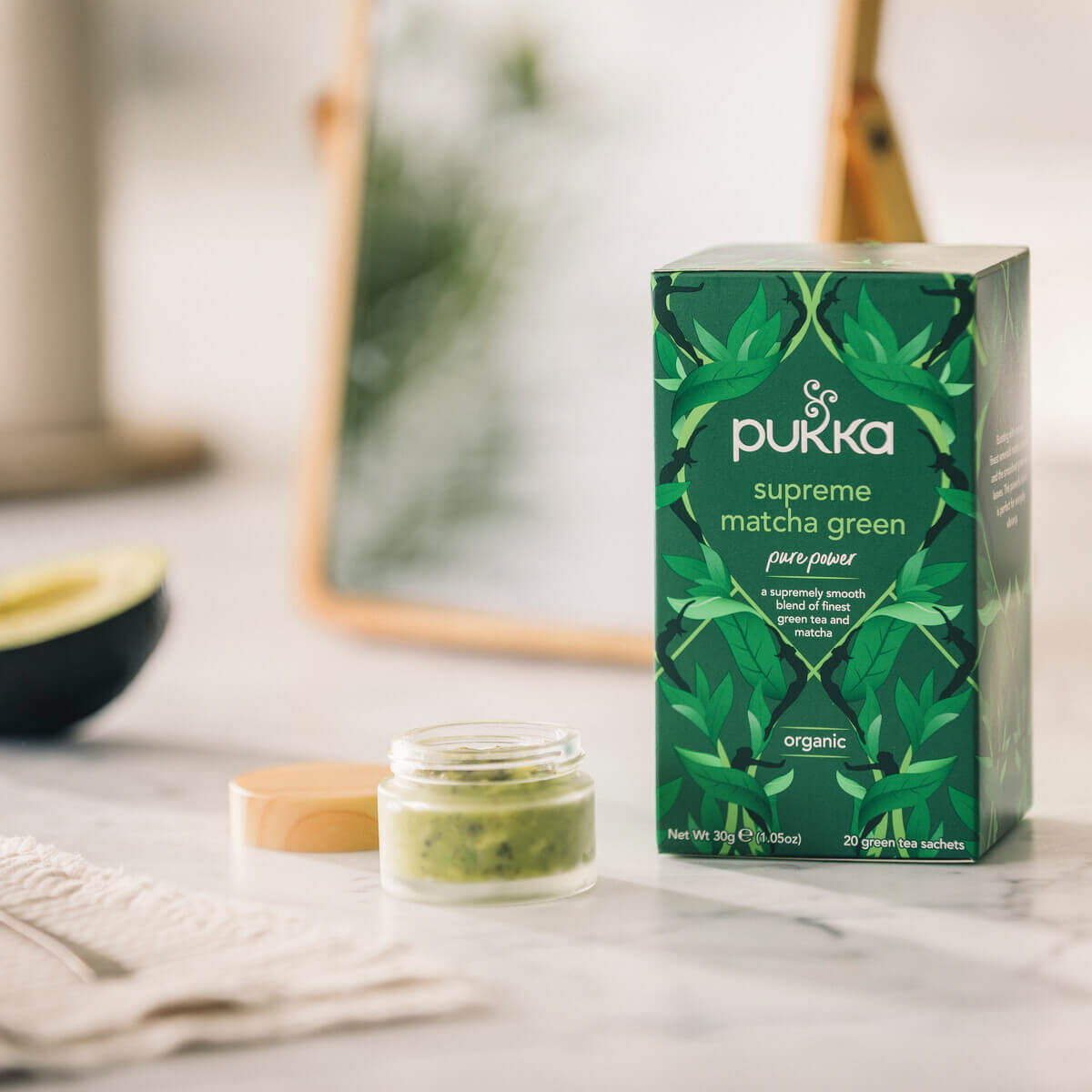 Pukka Supreme Matcha Green organic tea, 20 sachets, displayed next to a small jar of green matcha mask.