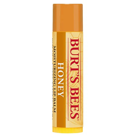 A Burt’s Bees "Honey" Moisturizing Lip Balm tube, featuring a golden-orange cap and a cream-colored label with a textured honeycomb and floral pattern.