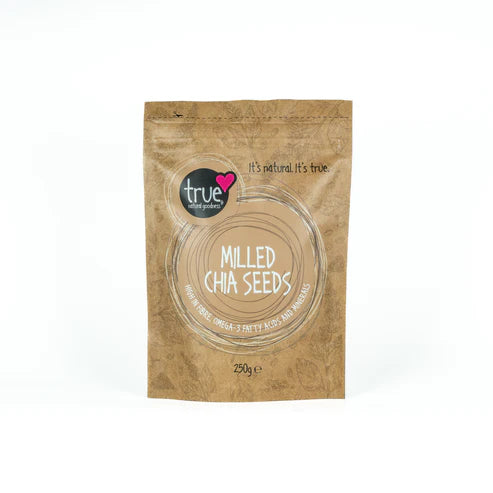 A 250g brown paper pouch of True Milled Chia Seeds with a tan circular label and subtle leaf illustrations.