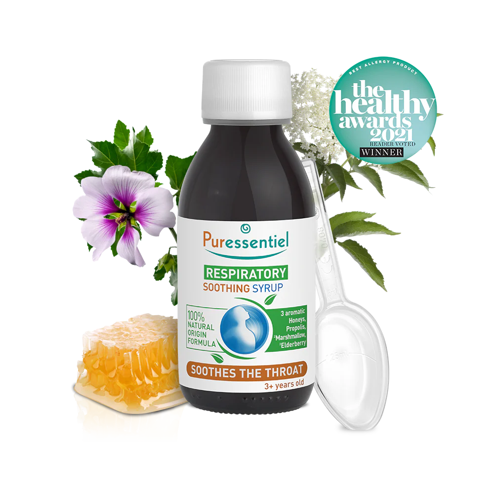 Puressentiel respiratory soothing syrup bottle with honeycomb, a purple flower, and a plastic measuring spoon.