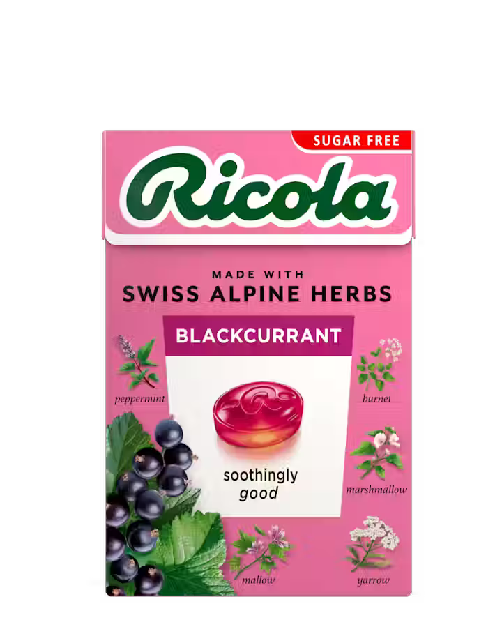 Pink sugar-free Ricola Blackcurrant herb drops box with botanical illustrations.