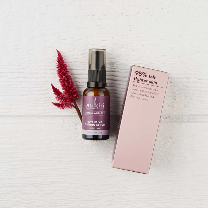 Sukin Purely Ageless Intensive Firming Serum surrounded by green botanical leaves.