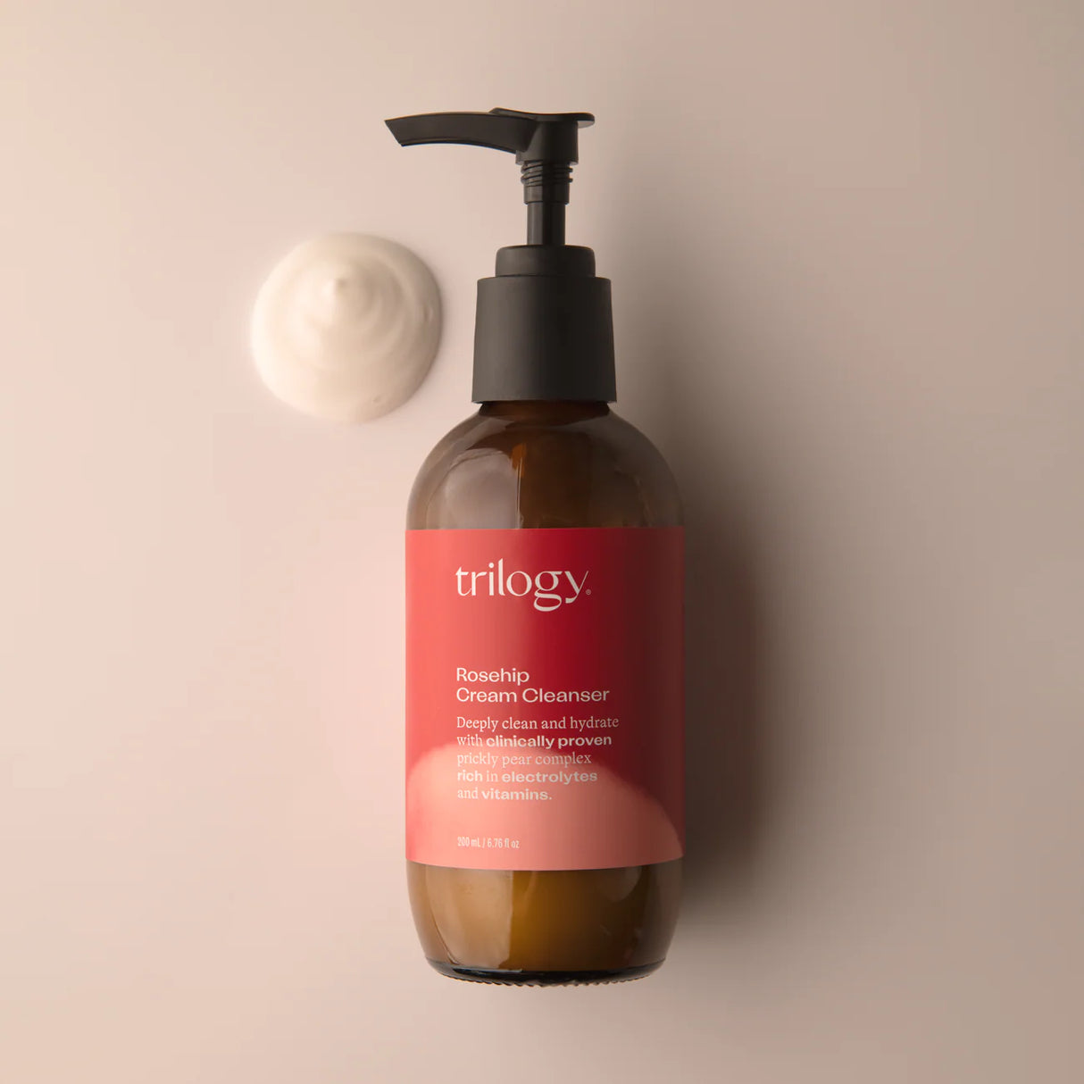 Trilogy cream cleaser rosehip in a brown galass bottle with a pump and a rose and red label
