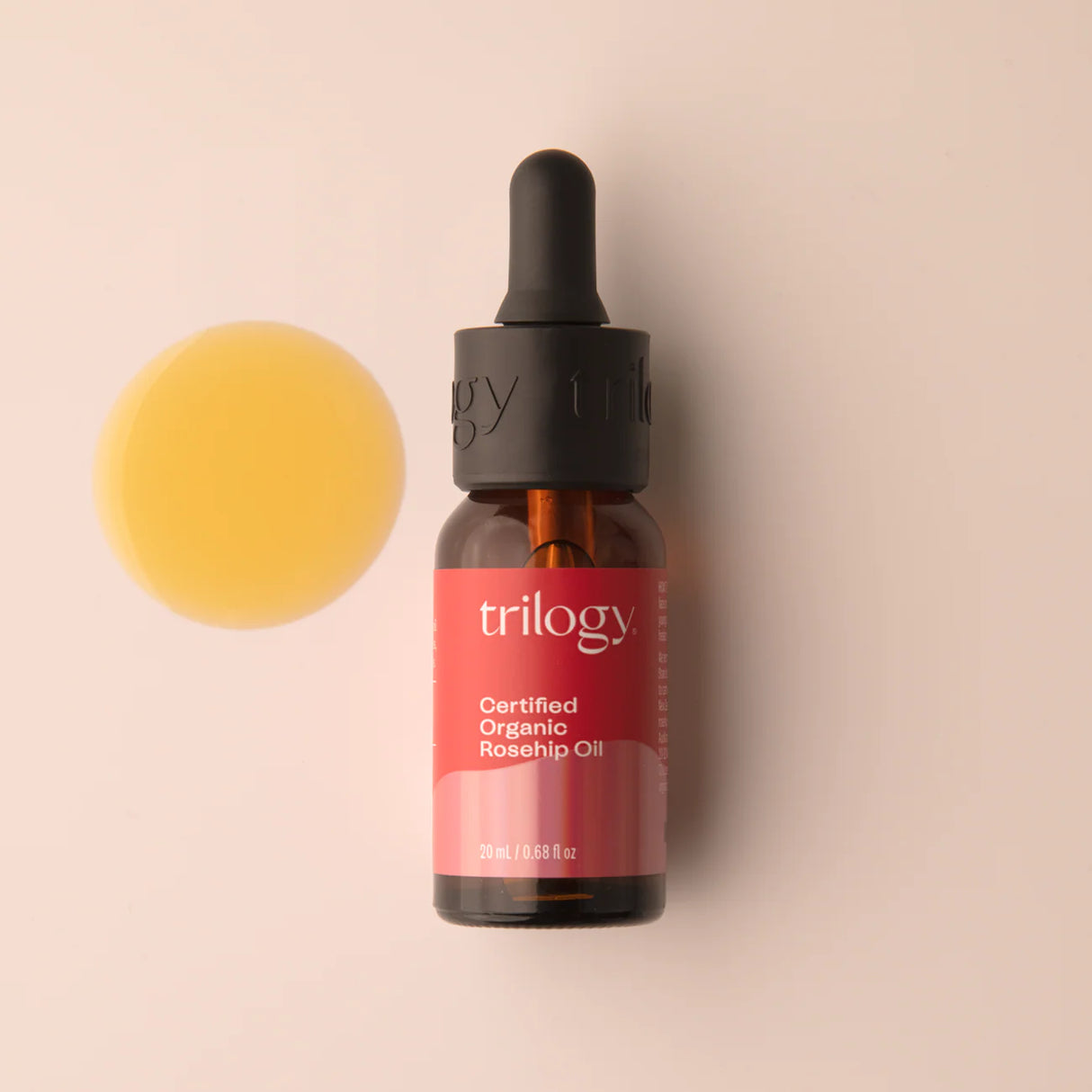 A 20ml amber glass bottle of Trilogy Certified Organic Rosehip Oil with a black dropper cap and a signature red label.