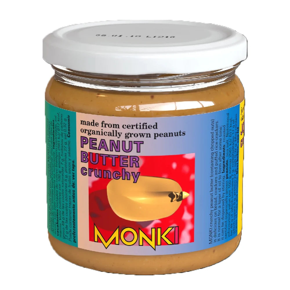 A glass jar of Monki Crunchy Peanut Butter with a white lid, featuring a colorful label that states it is "made from certified organically grown peanuts.