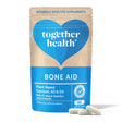 Together Health Bone Aid: A resealable pouch of Together Health Bone Aid, a plant-based food supplement containing Calcium, K2, and D3 along with 72 natural bioactive trace minerals. The packaging emphasizes that it contains no artificial additives and includes 60 easy-to-take capsules.