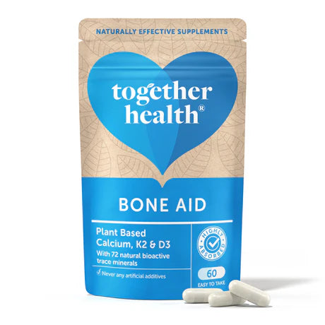 Together Health Bone Aid: A resealable pouch of Together Health Bone Aid, a plant-based food supplement containing Calcium, K2, and D3 along with 72 natural bioactive trace minerals. The packaging emphasizes that it contains no artificial additives and includes 60 easy-to-take capsules.