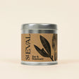 St. Eval Bay & Rosemary scented candle in a signature tin, featuring a natural kraft paper label with a botanical illustration.