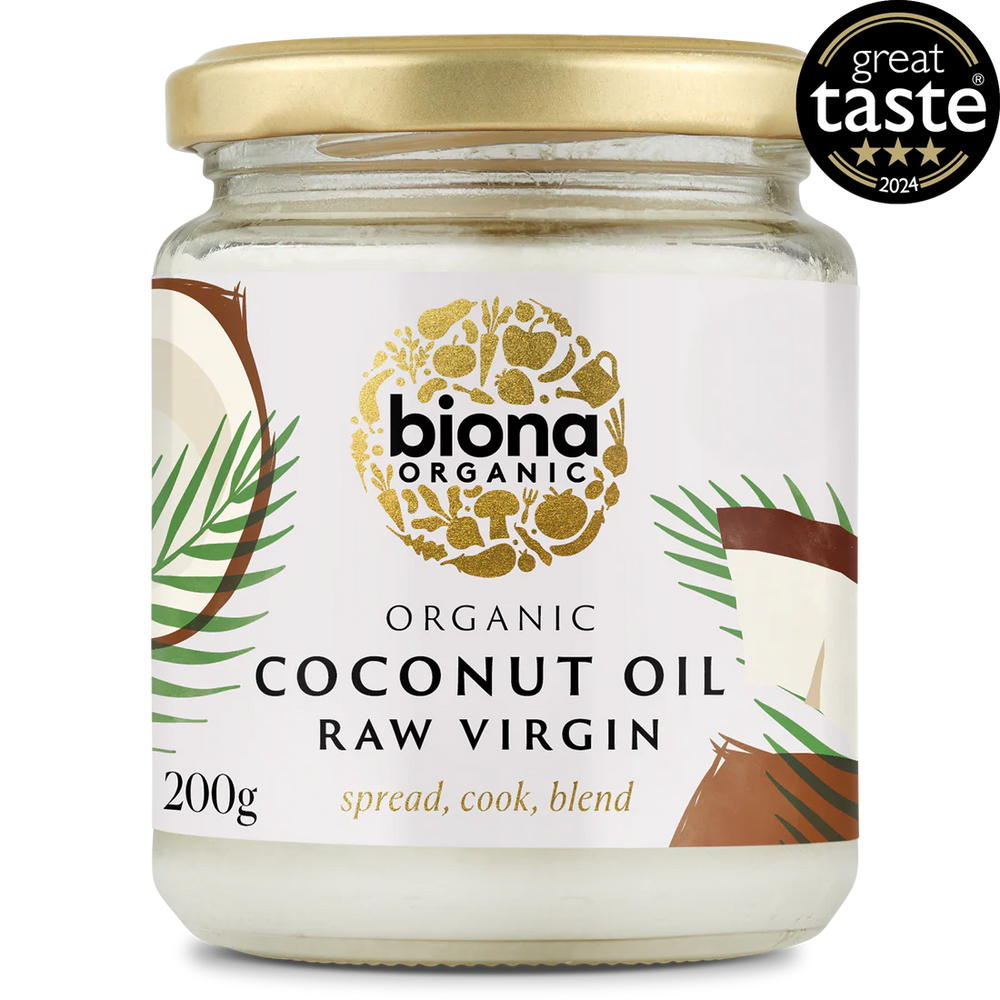 A jar of Biona Organic Raw Virgin Coconut Oil with a gold lid and tropical design, featuring palm leaves and coconut imagery. It has a "Great Taste 2024" award badge.
