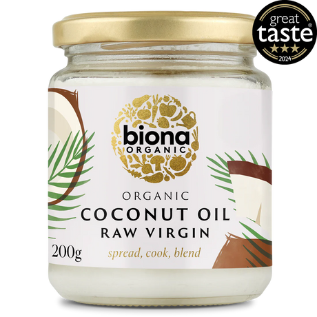 A jar of Biona Organic Raw Virgin Coconut Oil with a gold lid and tropical design, featuring palm leaves and coconut imagery. It has a "Great Taste 2024" award badge.