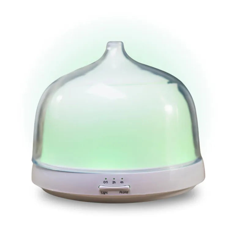 A bell-shaped glass ultrasonic aroma diffuser with a white base, glowing with a soft green light and featuring "Light" and "Aroma" control buttons.