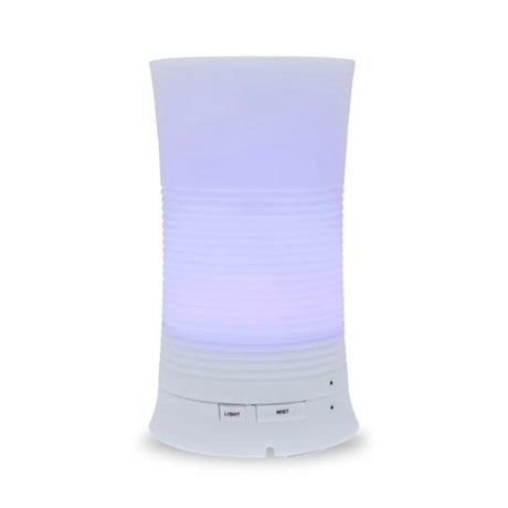 A tall, cylindrical white aroma diffuser with a rippled texture in the center, glowing with a soft purple light and featuring "Light" and "Mist" control buttons.