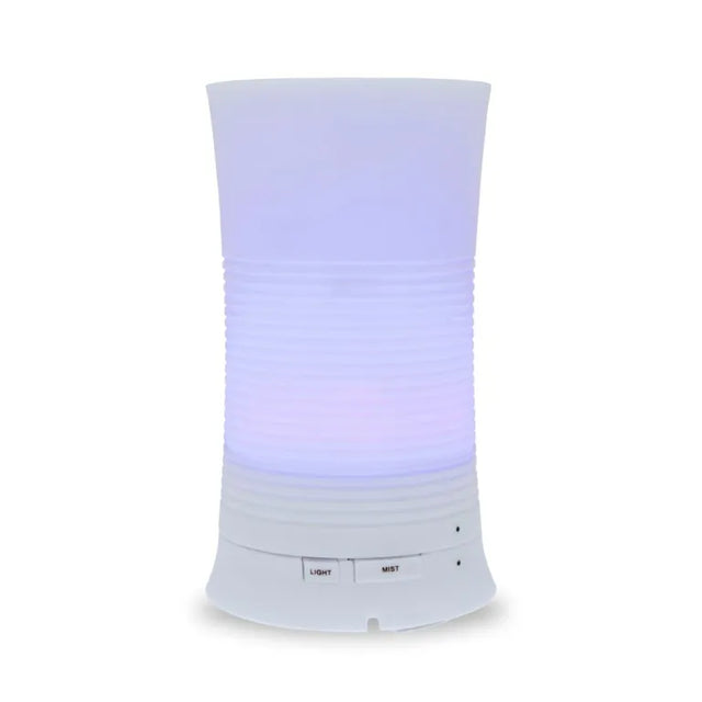 A tall, cylindrical white aroma diffuser with a rippled texture in the center, glowing with a soft purple light and featuring "Light" and "Mist" control buttons.