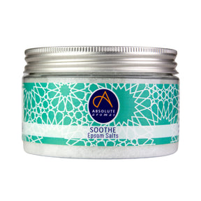 A clear jar of Absolute Aromatics Soothe Epsom Salts with a silver screw-top lid and a teal geometric pattern label on a white background.