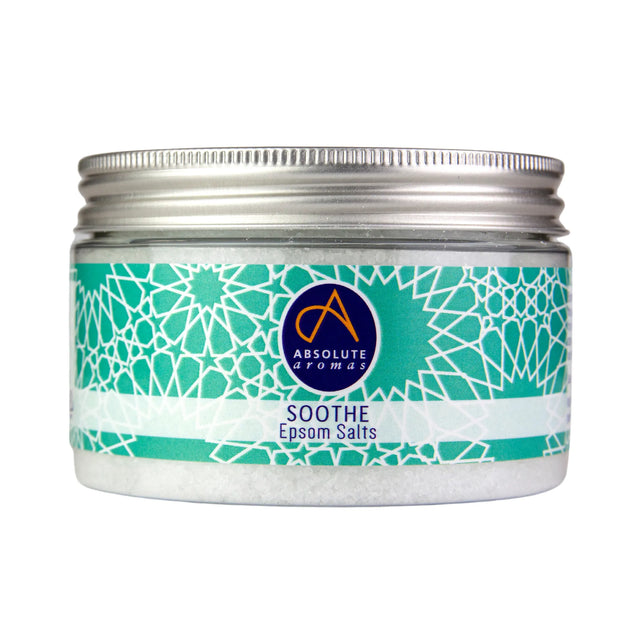 A clear jar of Absolute Aromatics Soothe Epsom Salts with a silver screw-top lid and a teal geometric pattern label on a white background.