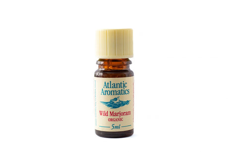 A 5ml amber glass bottle of Atlantic Aromatics Organic Wild Marjoram essential oil with a cream-colored ribbed cap on a white background.