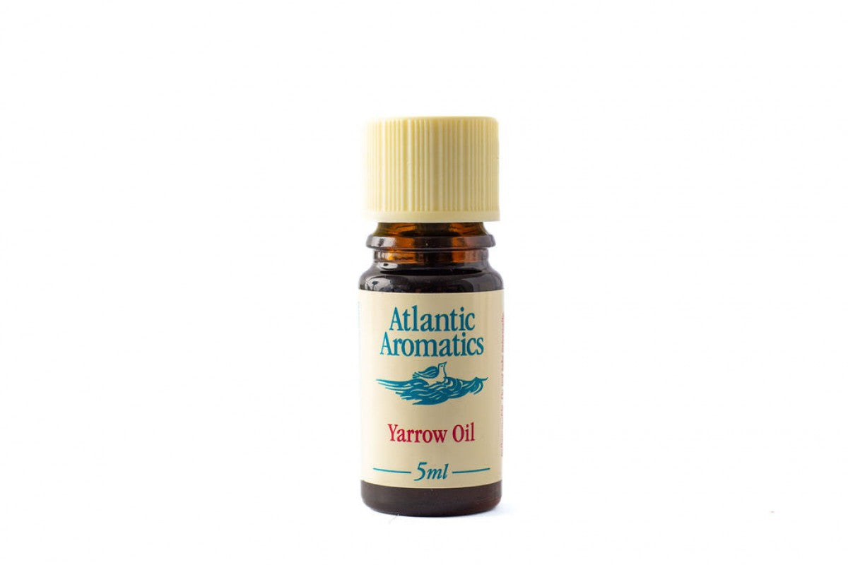 A 5ml amber glass bottle of Atlantic Aromatics Yarrow Oil with a cream label and a ribbed beige cap.