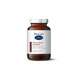 A 30-capsule amber glass jar of BioCare Antioxidant Complex food supplement with a white and maroon label and silver cap, isolated on a white background.