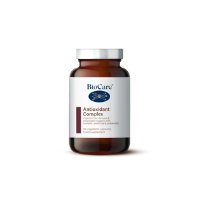 A 30-capsule amber glass jar of BioCare Antioxidant Complex food supplement with a white and maroon label and silver cap, isolated on a white background.