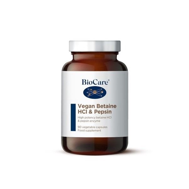 A 90-capsule amber glass jar of BioCare Vegan Betaine HCl & Pepsin food supplement with a white and navy blue label and silver cap, isolated on a white background.
