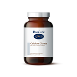 A 90-vegetable capsule amber glass jar of BioCare Calcium Citrate food supplement for bone and muscle support, featuring a white and light grey label and silver cap, isolated on a white background.
