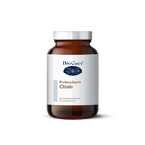 A 90-vegetable capsule amber glass jar of BioCare Potassium Citrate food supplement with a white and light grey label and silver cap, isolated on a white background.