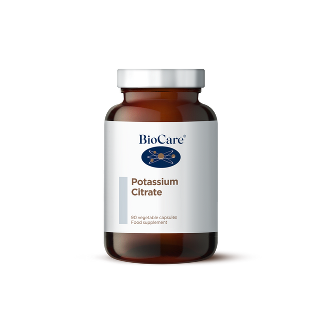 A 90-vegetable capsule amber glass jar of BioCare Potassium Citrate food supplement with a white and light grey label and silver cap, isolated on a white background.