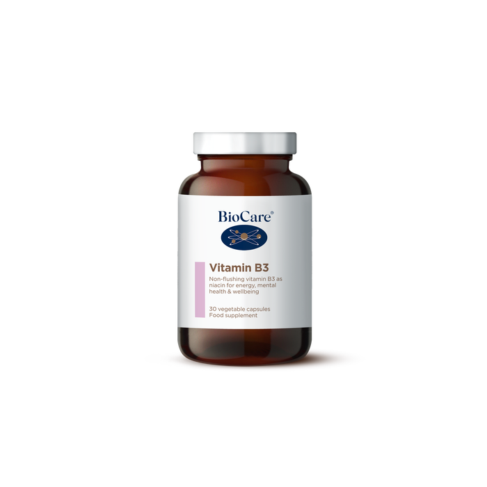 A 30-vegetable capsule amber glass jar of BioCare Vitamin B3 food supplement for energy, mental health, and wellbeing, featuring a white and light pink label and silver cap, isolated on a white background.