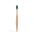 Wooden toothbrush with green bristles and engraved leaf pattern on the handle. The word "georganics" is etched into the handle, conveying an eco-friendly feel.