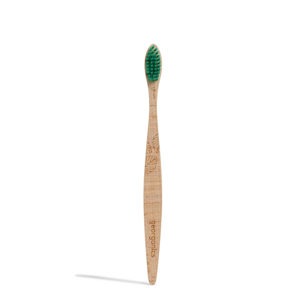 Wooden toothbrush with green bristles and engraved leaf pattern on the handle. The word "georganics" is etched into the handle, conveying an eco-friendly feel.