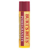 A Burt’s Bees "Pomegranate" Moisturizing Lip Balm tube, featuring a deep burgundy cap and a cream-colored label with a subtle honeycomb and pomegranate seed pattern.
