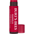 A Burt’s Bees Tinted Lip Balm in "Magnolia" shade, featuring a deep berry-pink tube with bold white vertical branding and a matching cap resting alongside. 