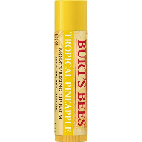 A Burt’s Bees "Tropical Pineapple" Moisturizing Lip Balm tube, featuring a vibrant yellow cap and a cream-colored label with a subtle pineapple graphic. 