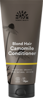 A dark grey squeeze tube of Urtekram Camomile Conditioner for blond hair with a black cap. The label features camomile flower illustrations, a thin yellow horizontal stripe, and specifies it is certified organic and 100% natural origin, with Vegan and Ecocert COSMOS Organic certifications.