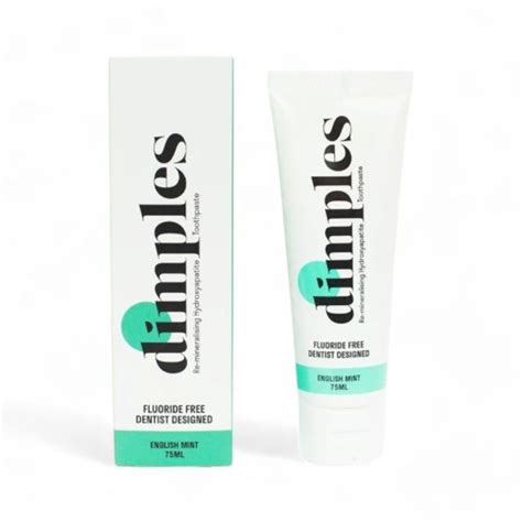 Dimples fluoride free toothpaste in English Mint, shown as a white squeeze tube next to its white packaging box with mint green accents.