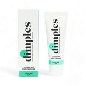 Dimples fluoride free toothpaste in English Mint, shown as a white squeeze tube next to its white packaging box with mint green accents.