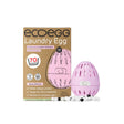 Eco Egg Laundry Egg in Spring Blossom scent, shown with its brown cardboard packaging box and the pink egg-shaped detergent dispenser alongside small plant-based detergent pods on a solid light pink background.