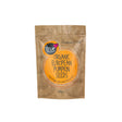 A 500g brown paper pouch of True Organic European Pumpkin Seeds with a large orange circular label and subtle seed illustrations.