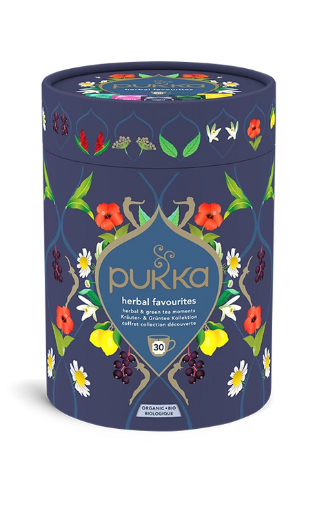 Pukka Organic "Herbal Favourites" tea selection box, a cylindrical navy blue container featuring a floral design and containing 30 herbal and green tea moments.
