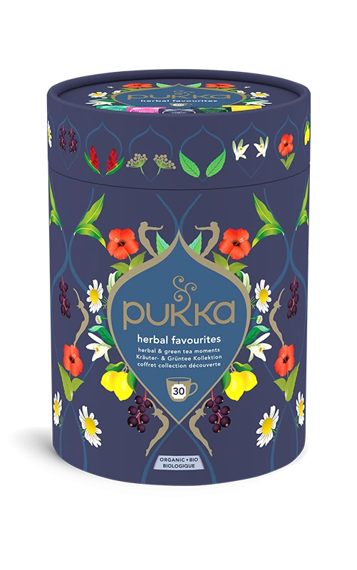 Pukka Organic "Herbal Favourites" tea selection box, a cylindrical navy blue container featuring a floral design and containing 30 herbal and green tea moments.