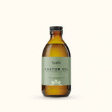 An amber glass bottle of Fushi Organic Fresh-Pressed 100% Pure Castor Oil.