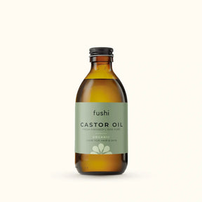 An amber glass bottle of Fushi Organic Fresh-Pressed 100% Pure Castor Oil.