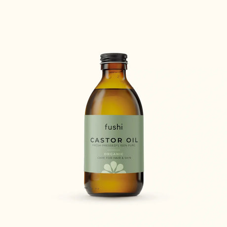 An amber glass bottle of Fushi Organic Fresh-Pressed 100% Pure Castor Oil.