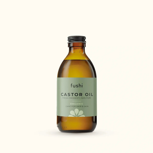 An amber glass bottle of Fushi Organic Fresh-Pressed 100% Pure Castor Oil.
