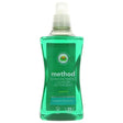 A bottle of Method concentrated laundry detergent in the Orchard Fruit scent, featuring a green liquid formula and a label highlighting its "powerful stain shifter" technology.