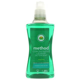A bottle of Method concentrated laundry detergent in the Orchard Fruit scent, featuring a green liquid formula and a label highlighting its "powerful stain shifter" technology.