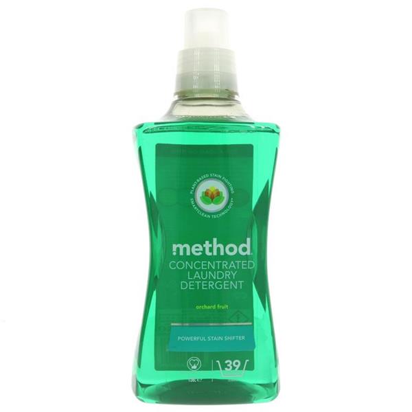 A bottle of Method concentrated laundry detergent in the Orchard Fruit scent, featuring a green liquid formula and a label highlighting its "powerful stain shifter" technology.