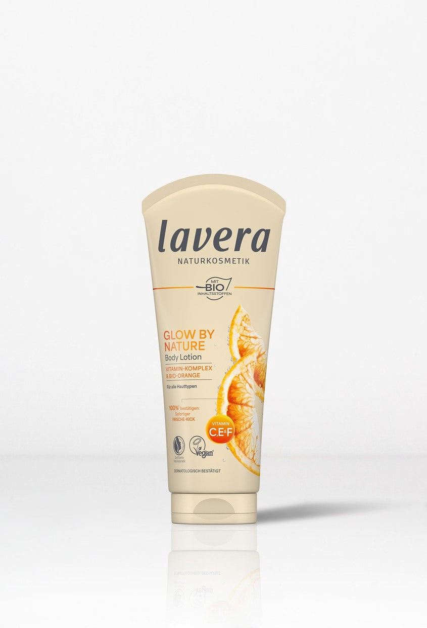 Minimalist studio shot of Lavera Glow By Nature orange body lotion.