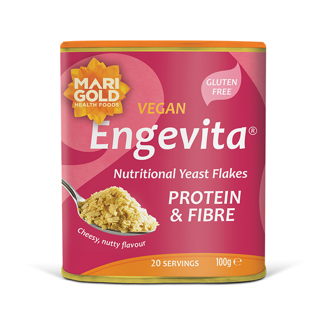 Marigold Engevita nutritional yeast flakes canister with protein & fibre on a solid black background.
