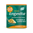 Marigold Engevita nutritional yeast flakes canister with a spoonful of flakes.